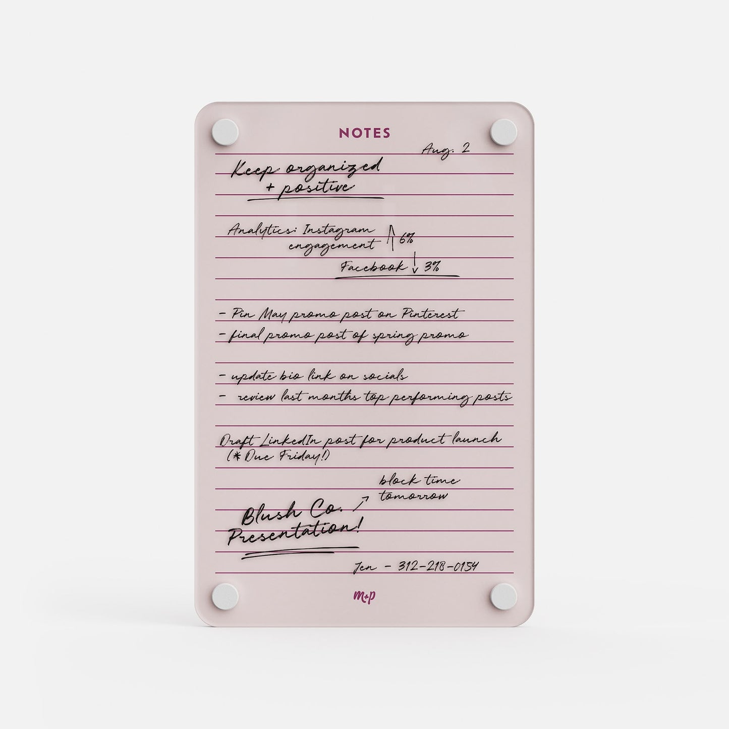 The Lined Notes 69 pink notepad works as a planning board, with handwritten lists for Instagram, Facebook, Pinterest posts, product launch drafts, and a presentation. A contact number is neatly organized at the bottom.