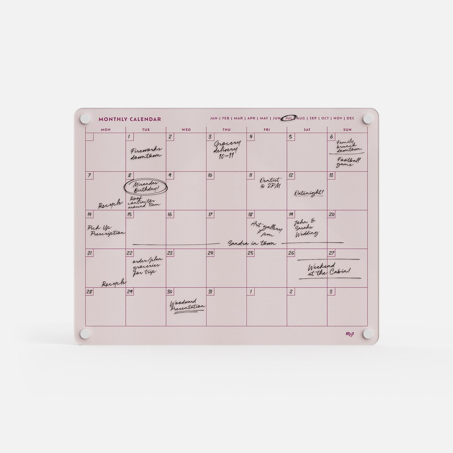 The Monthly Calendar 1411 is a pink, dry-erase family planner with handwritten notes and four white magnets. Months are displayed in a row at the top for easy tracking of plans and events.