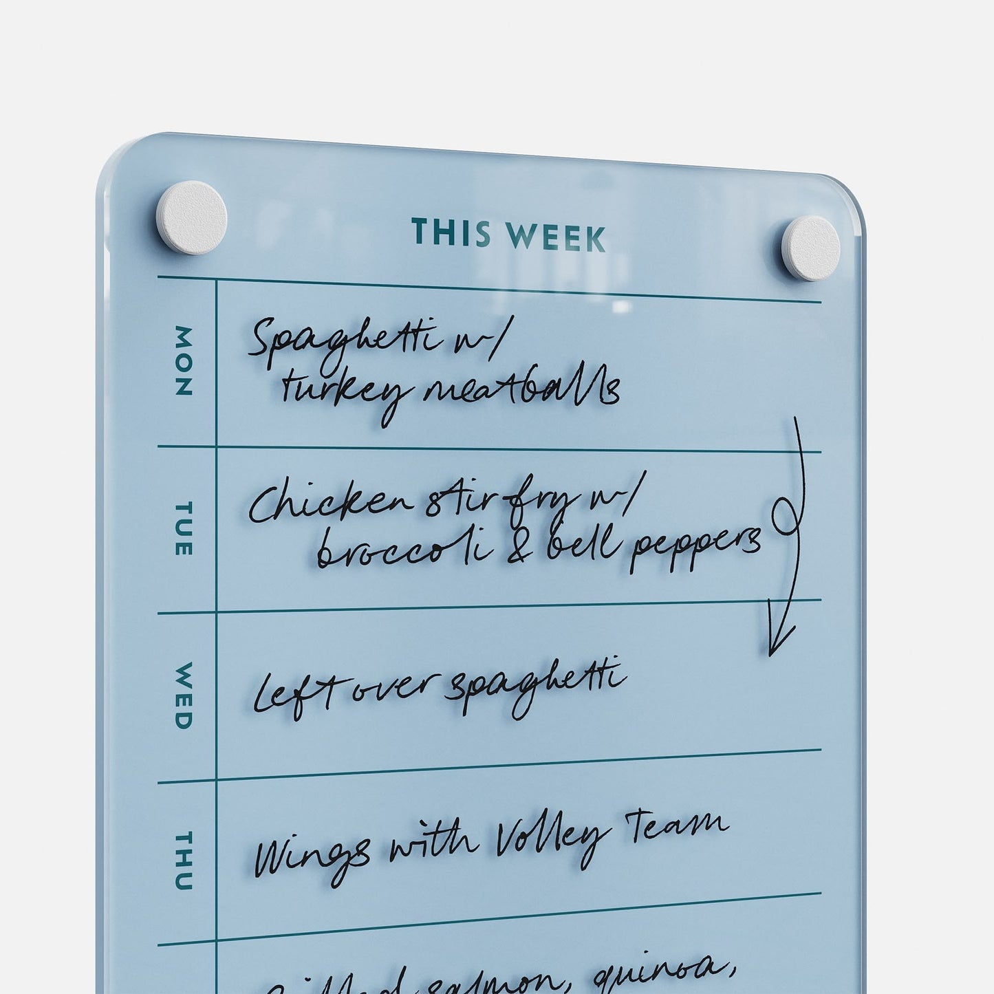 The "This Week 69" blue weekly organizer on a whiteboard lists meals: Monday—spaghetti with turkey meatballs; Tuesday—chicken stir-fry; Wednesday—leftovers; Thursday—wings with the volleyball team.