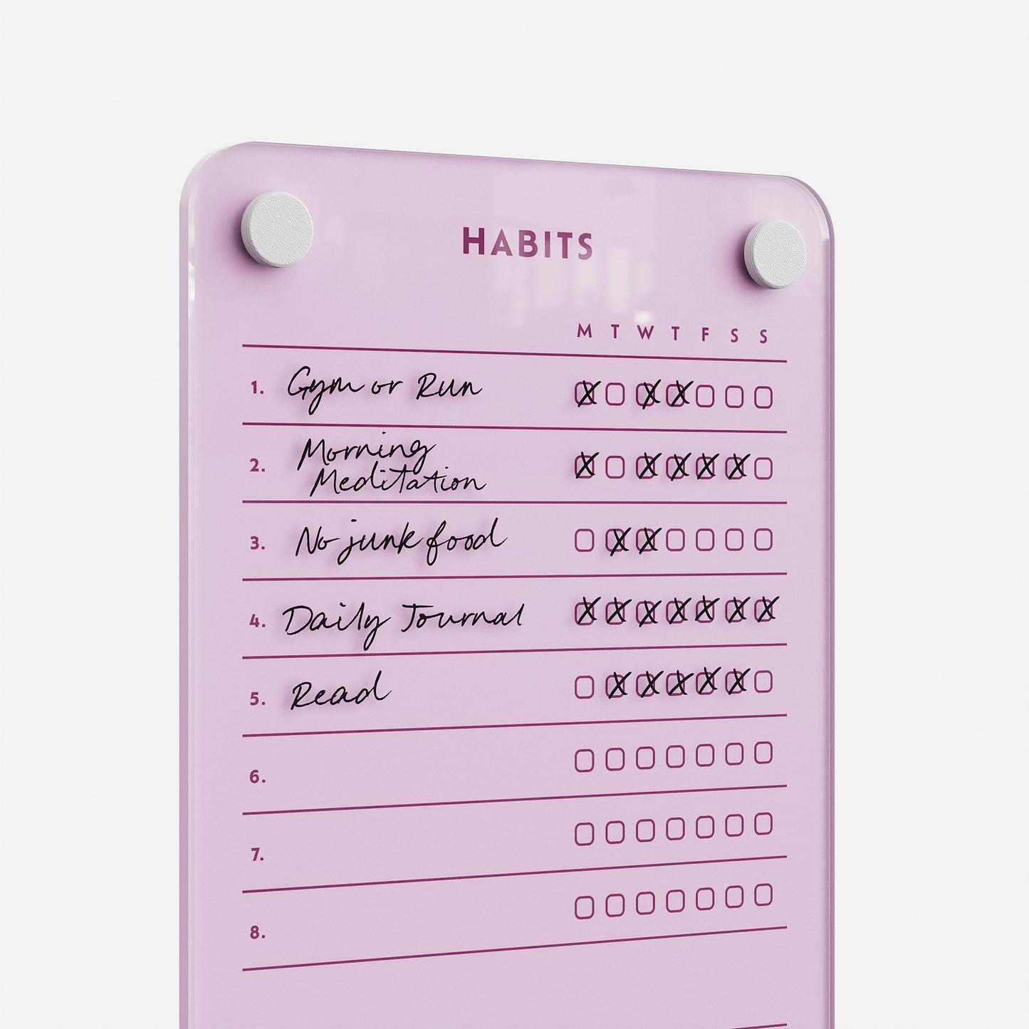 The Weekly Habits 59 board is a pink dry-erase tracker featuring checkboxes for days of the week and five habits: Gym or Run, Morning Meditation, No junk food, Daily Journal, and Read—some boxes are already checked to show progress.