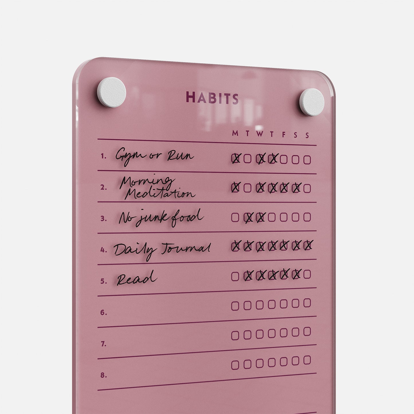 The Weekly Habits 59 is a pink habit tracker board for daily goals like Gym, Morning Meditation, No Junk Food, Daily Journal, and Reading. Checkboxes track progress for each day. Two magnets keep this stylish board securely in place.