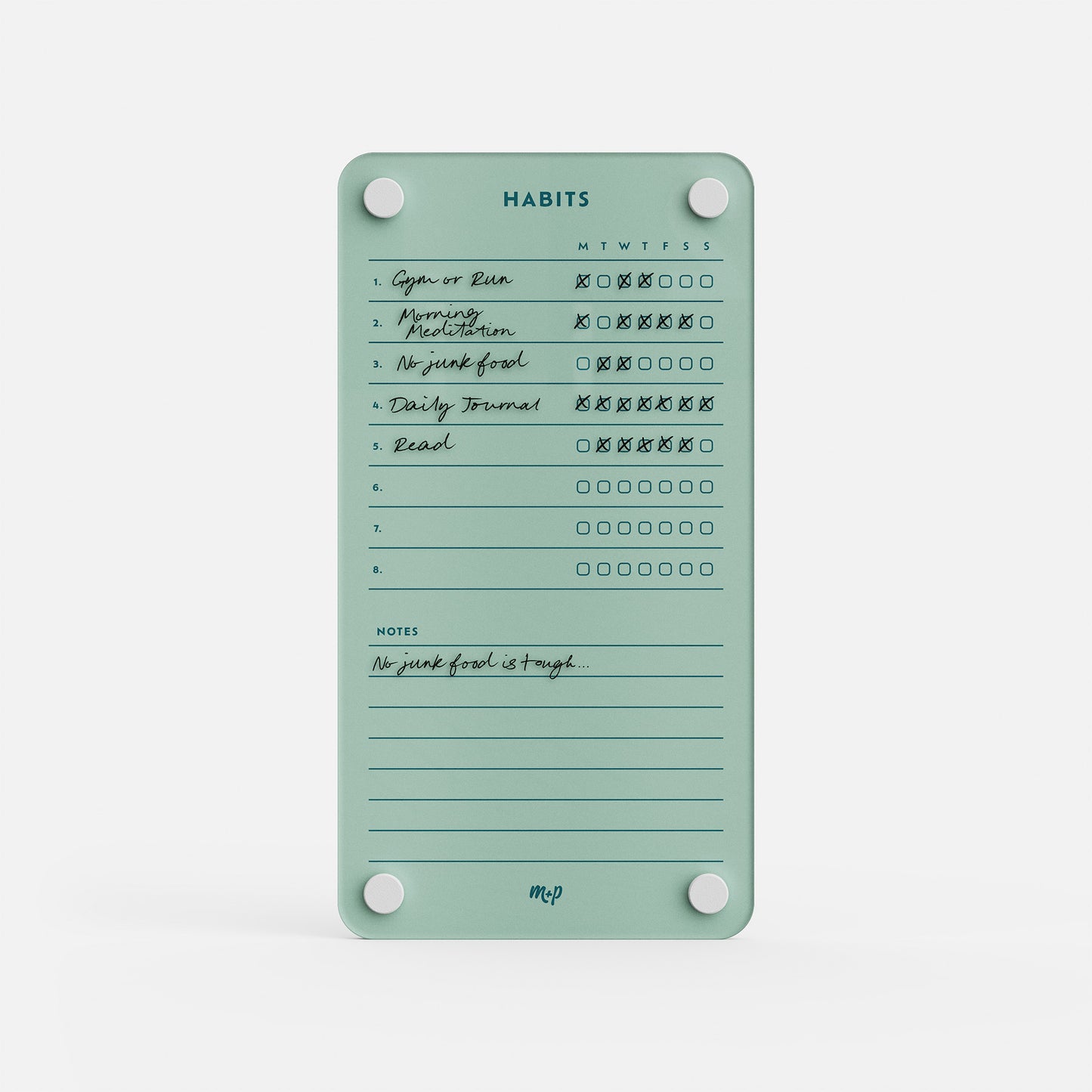 Premium acrylic erasable, reusable habit tracker in teal with six weekly goals, checked boxes, and a “No junk food is tough” note.