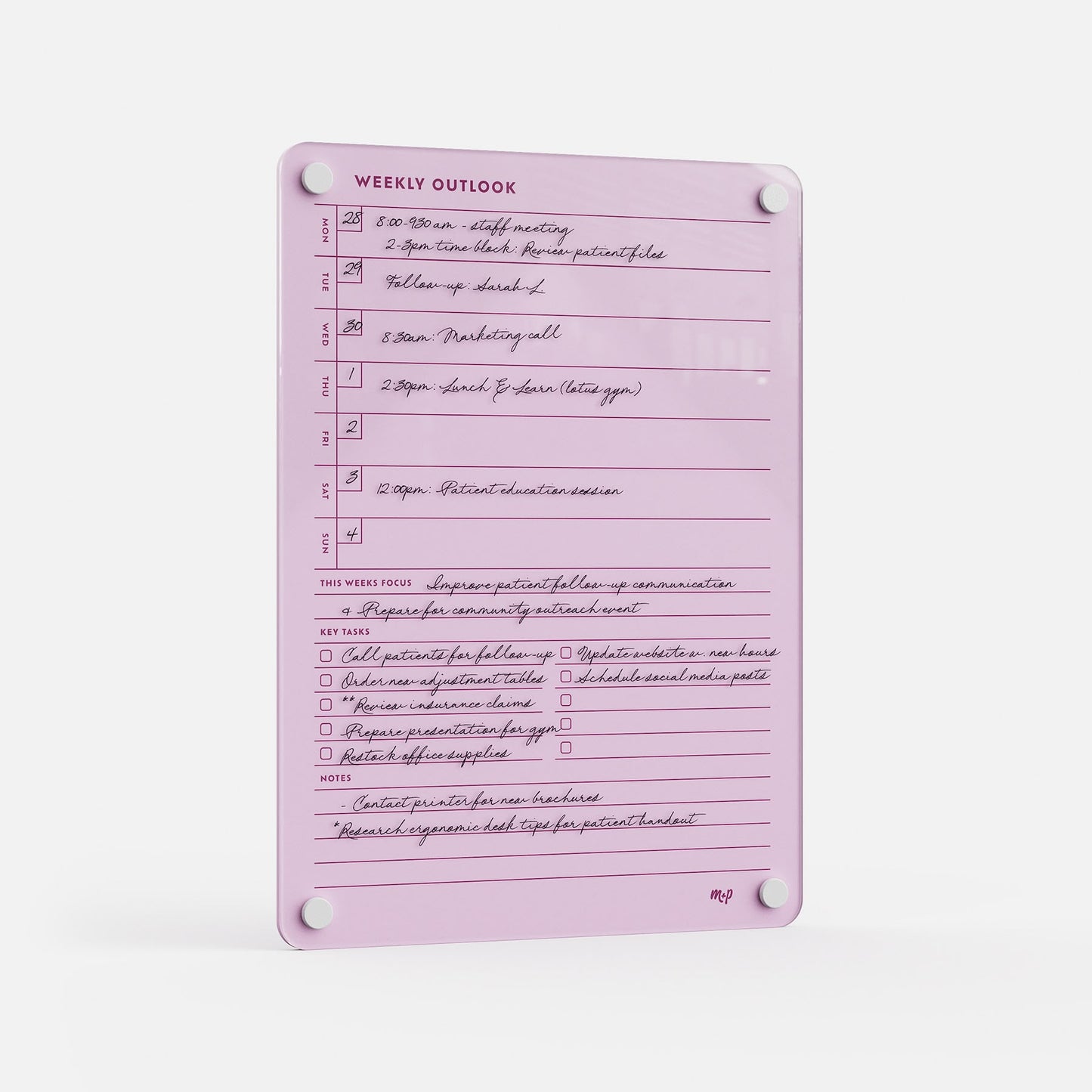 The Weekly Outlook 811 is a pink weekly planner board featuring sections for focus, key tasks, notes, handwritten appointments, and to-dos. This productivity organizer mounts easily with four white corner fasteners.