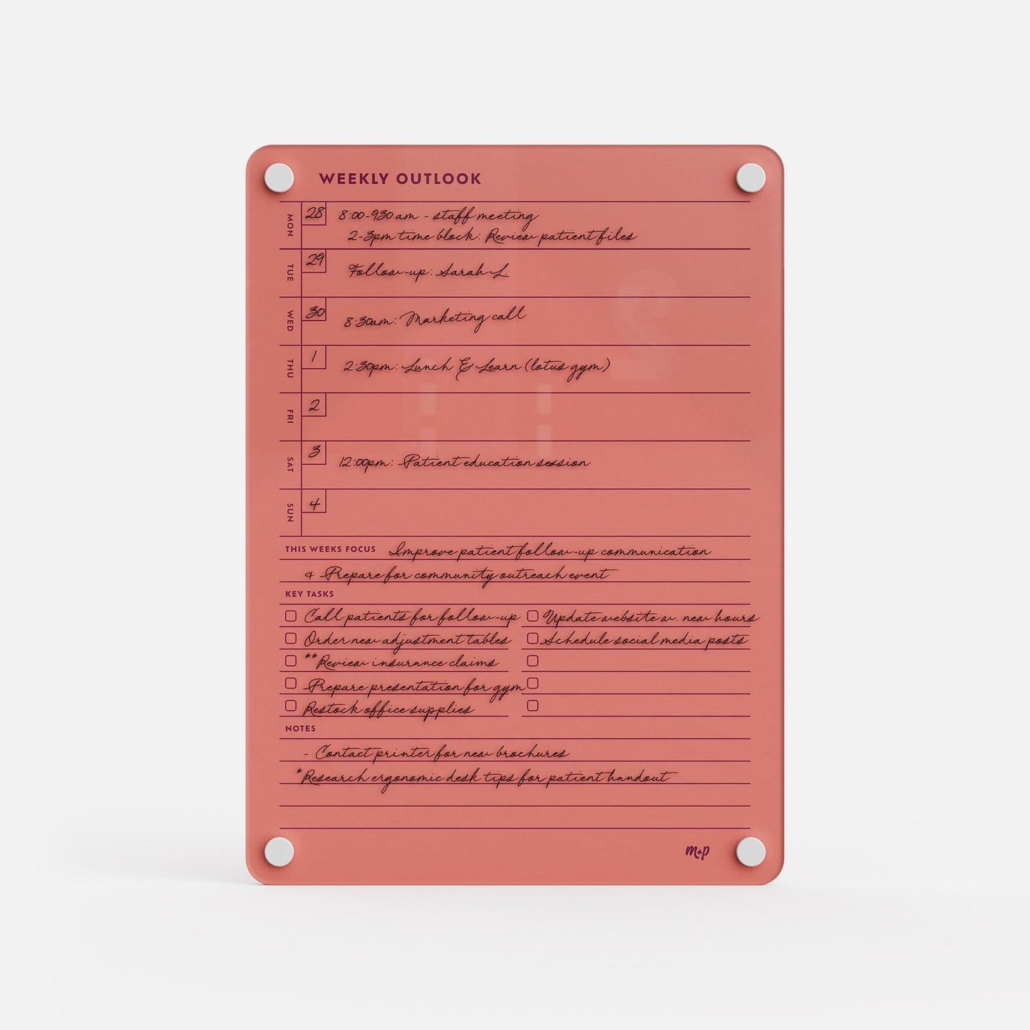 The Weekly Outlook 811 is a coral-colored planner and productivity organizer with handwritten tasks, scheduled times, sections for outlook, goals, notes, completion checkboxes, and silver fasteners securing the corners.