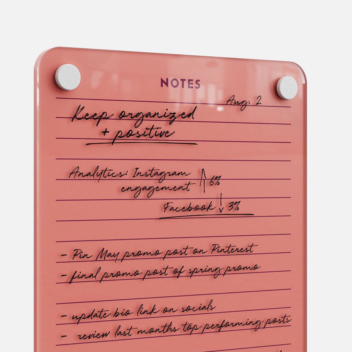 The Lined Notes 69 glass planning board with pink corners displays handwritten reminders, analytics, and an Instagram/Facebook to-do list—ideal for organizing and tracking social media tasks. The heading reads NOTES.