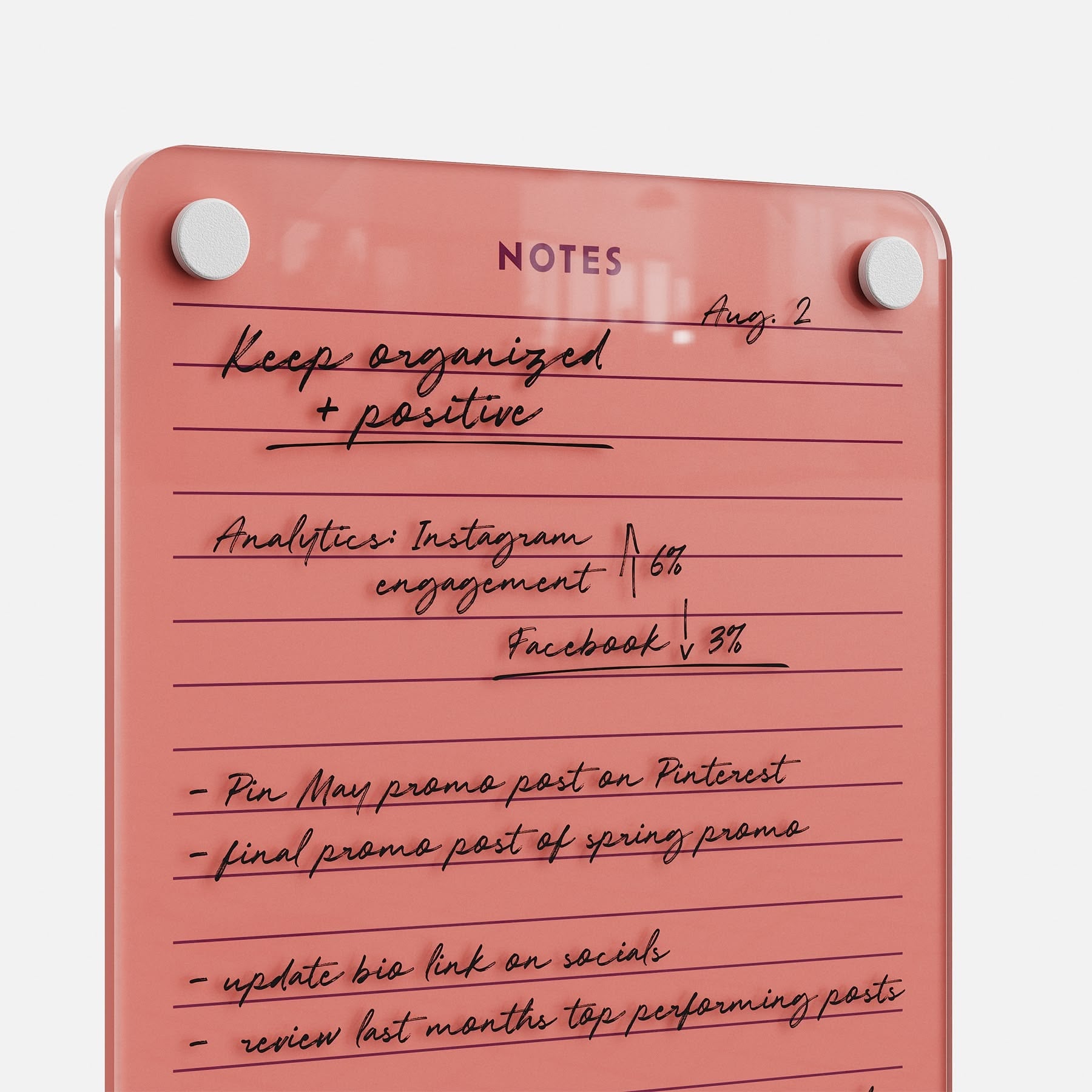 The Lined Notes 69 glass planning board with pink corners displays handwritten reminders, analytics, and an Instagram/Facebook to-do list—ideal for organizing and tracking social media tasks. The heading reads NOTES.