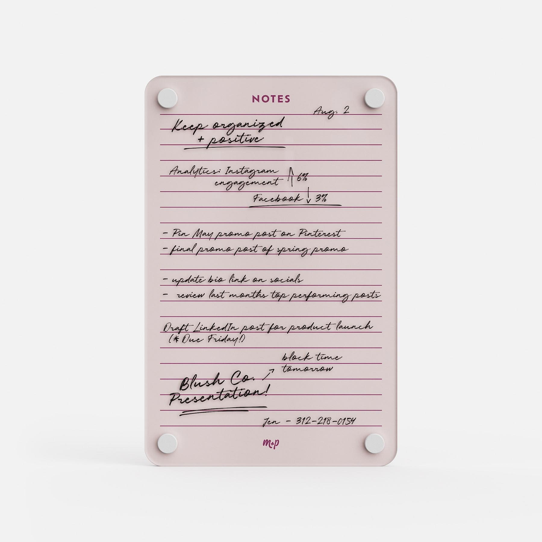 The Lined Notes 69 pink notepad works as a planning board, with handwritten lists for Instagram, Facebook, Pinterest posts, product launch drafts, and a presentation. A contact number is neatly organized at the bottom.