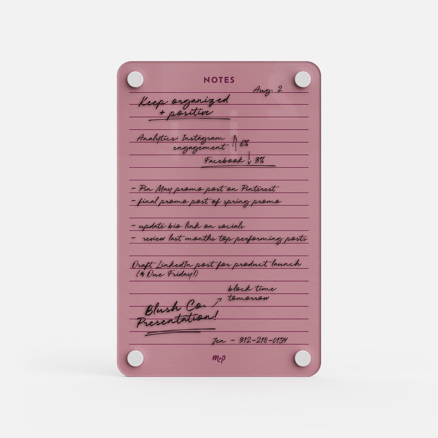 The "Lined Notes 69" notepad in pink is labeled NOTES and displays handwritten to-do lists, dates, and reminders for social media tasks, product launches, and presentations, plus a phone number and the initials MP at the bottom for organization.