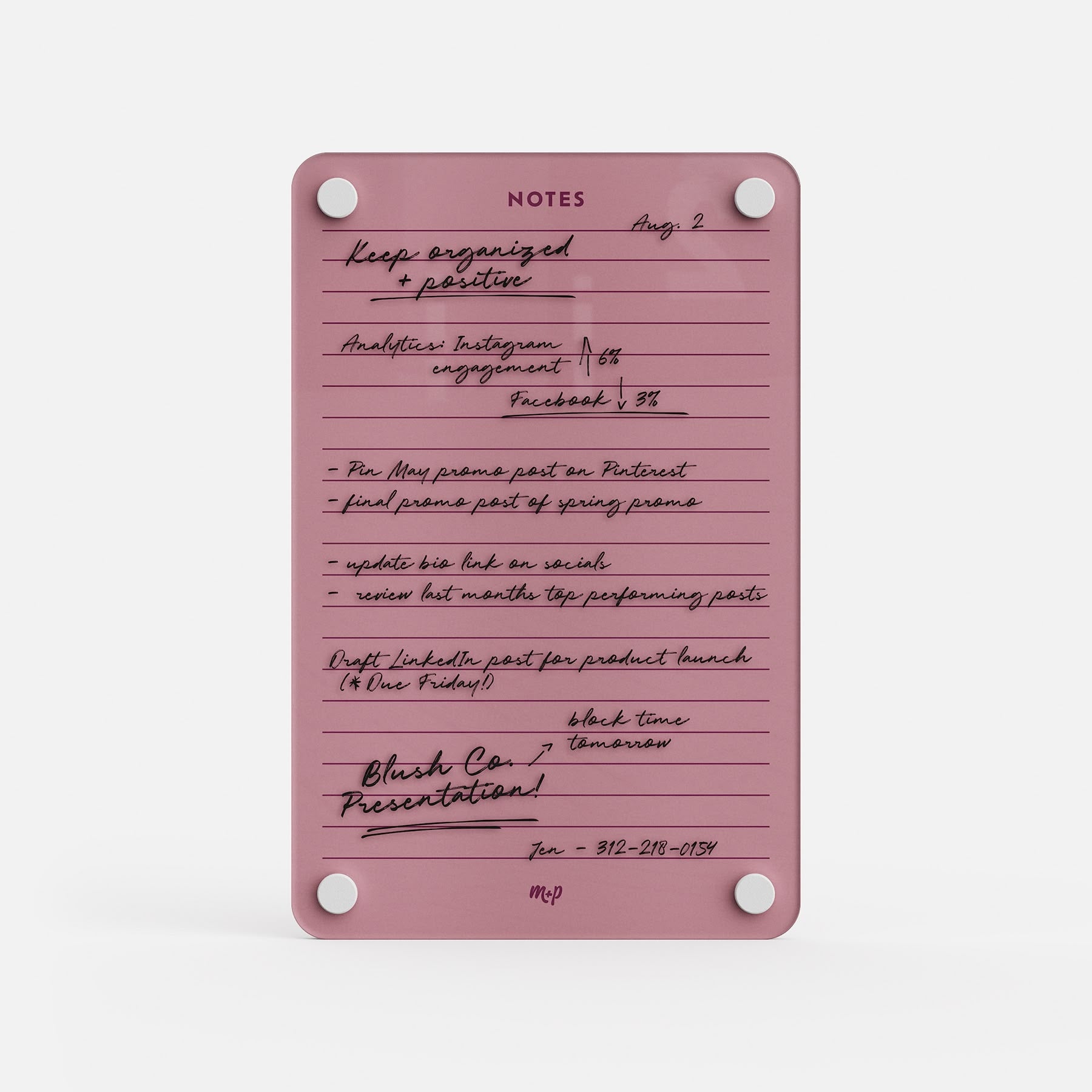 The "Lined Notes 69" notepad in pink is labeled NOTES and displays handwritten to-do lists, dates, and reminders for social media tasks, product launches, and presentations, plus a phone number and the initials MP at the bottom for organization.
