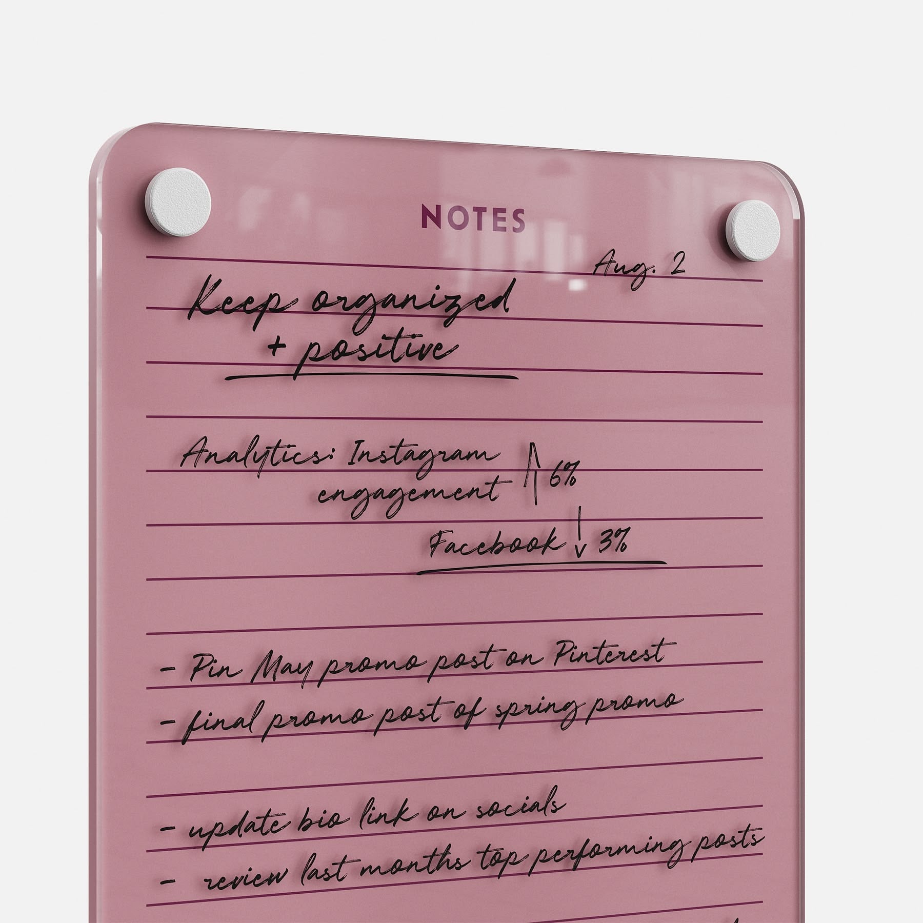 Stay organized and positive with Lined Notes 69, a pink glass dry-erase board for handwritten lists, tracking Instagram and Facebook analytics, posting promos, updating your social bio link, and reviewing top posts.