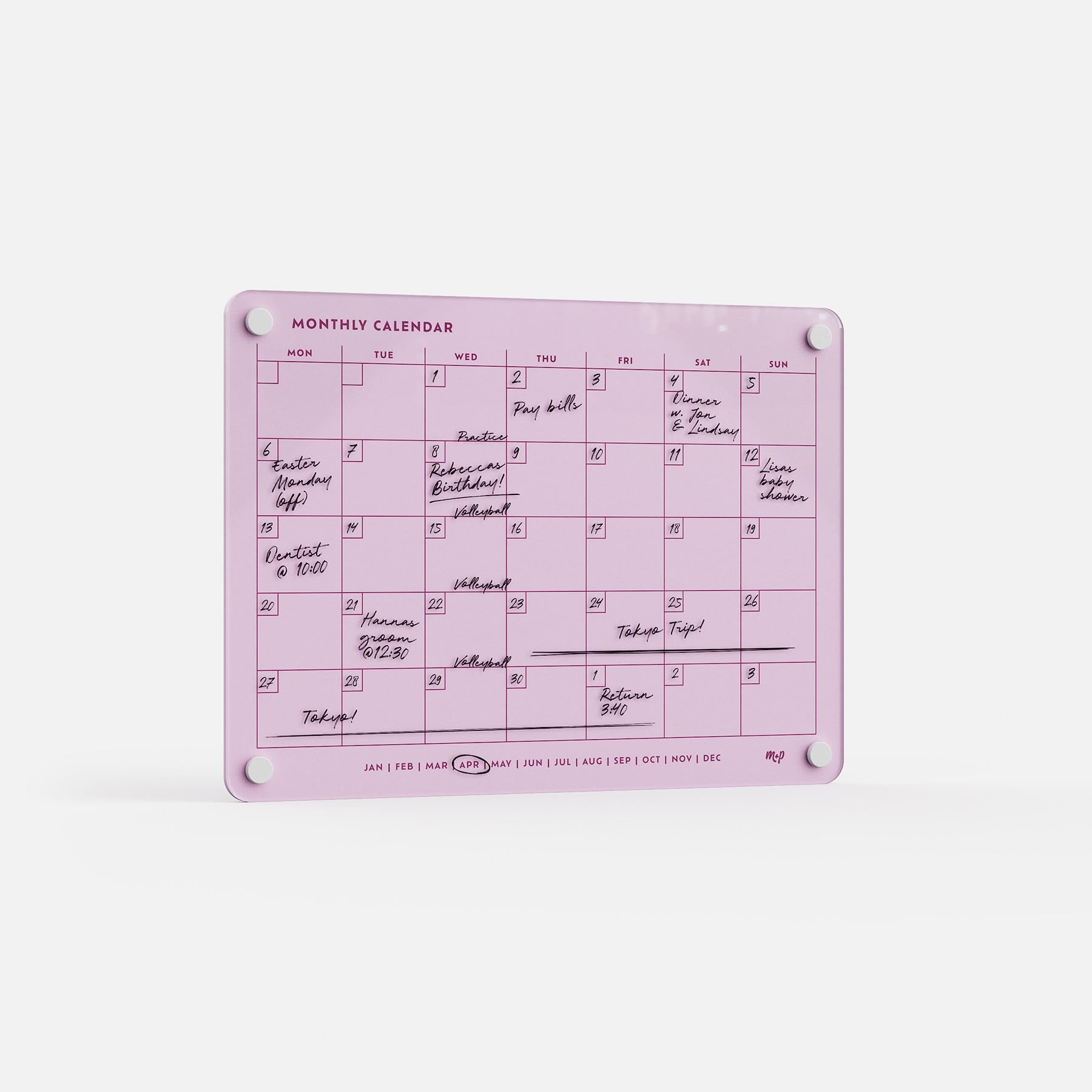 The Monthly Calendar 118 is a pink compact planner shown upright, with handwritten events and notes in black marker. Days of the week and month abbreviations line the top and bottom, making it an ideal organizer for families.