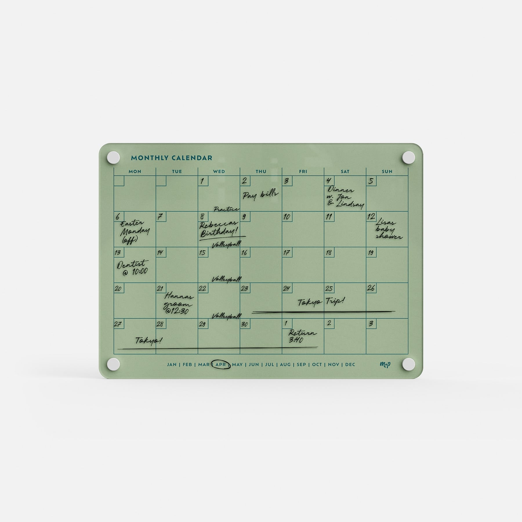 The Monthly Calendar 118 is a green, reusable planner with handwritten events on most days. This compact calendar has days of the week labeled at the top, months along the bottom, and four corner holes for easy mounting.