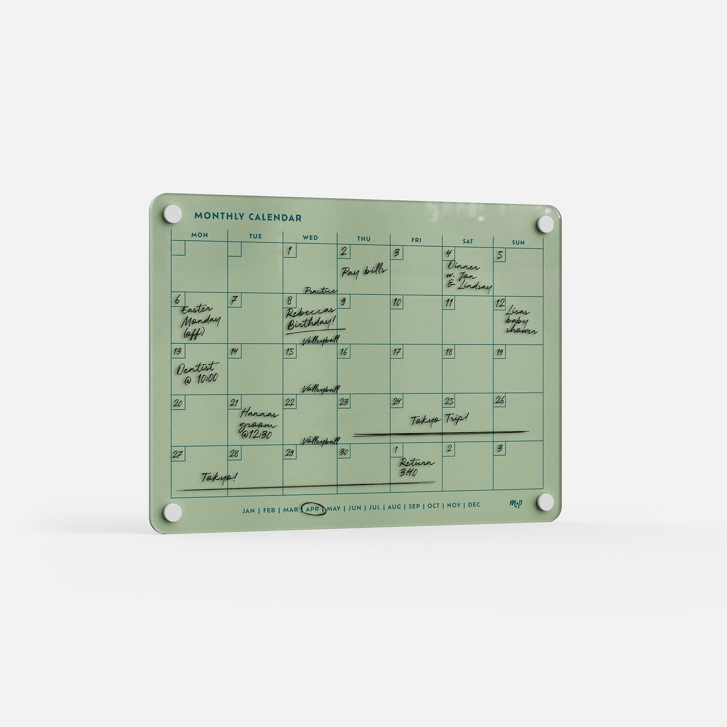 The Monthly Calendar 118 is a green, compact monthly planner with handwritten black events, four corner holes, abbreviated months along the bottom edge, and a white background.