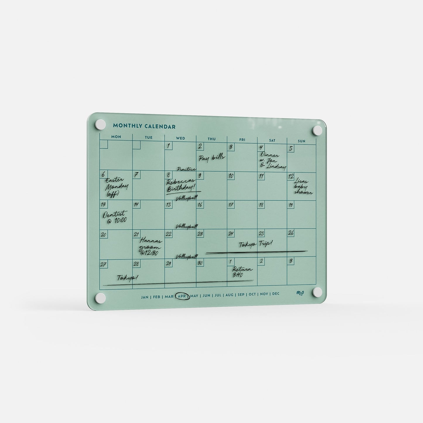 The Monthly Calendar 118 is a teal acrylic compact calendar with daily boxes, handwritten events in black ink, and four mounting holes—ideal as a family organizer on any white surface.