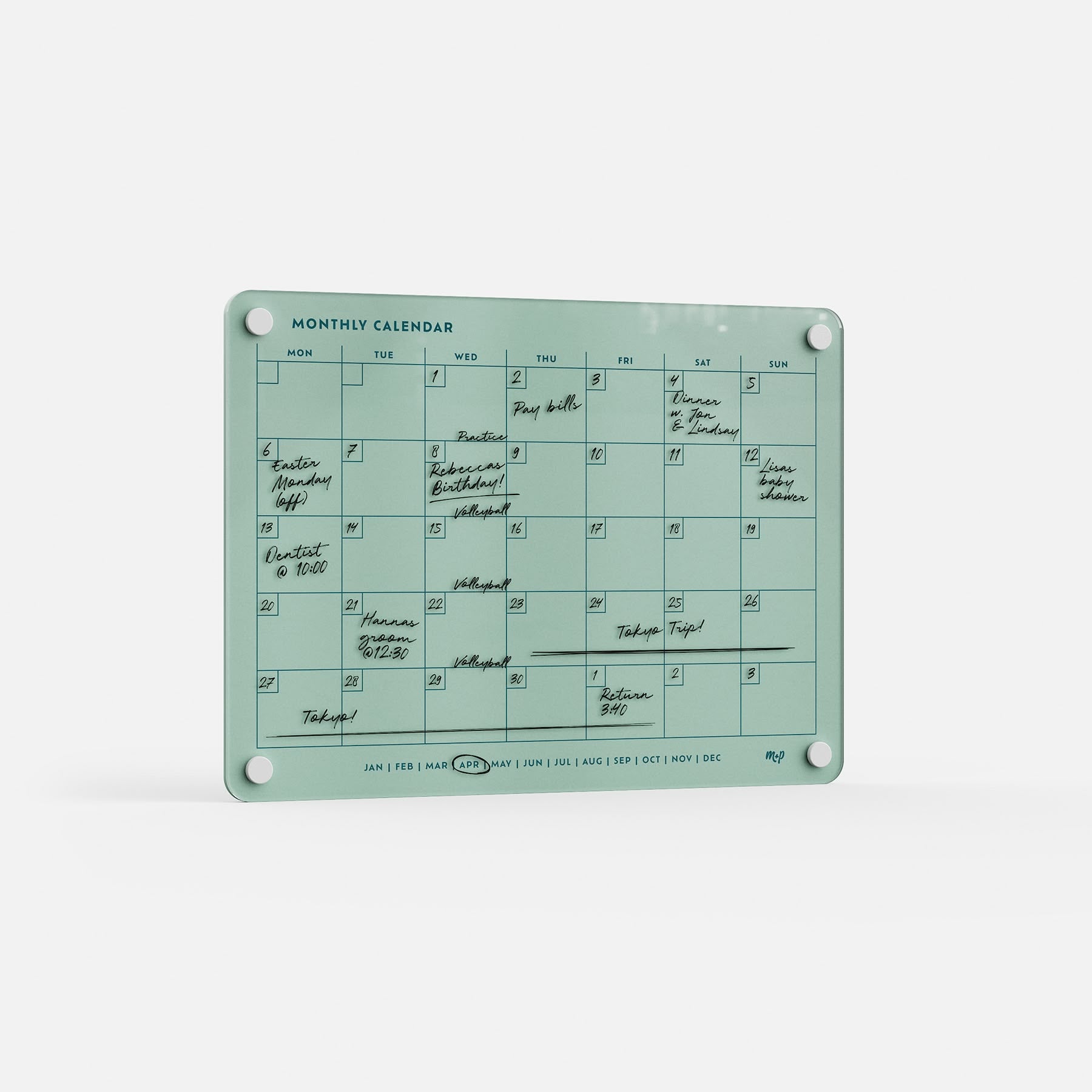 The Monthly Calendar 118 is a teal acrylic compact calendar with daily boxes, handwritten events in black ink, and four mounting holes—ideal as a family organizer on any white surface.