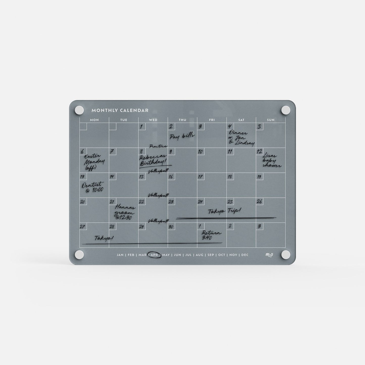 The Monthly Calendar 118 is a gray, reusable compact planner featuring handwritten black marker notes. With columns for each weekday and wall-mount circles in each corner, it’s perfect for organizing your month’s events.