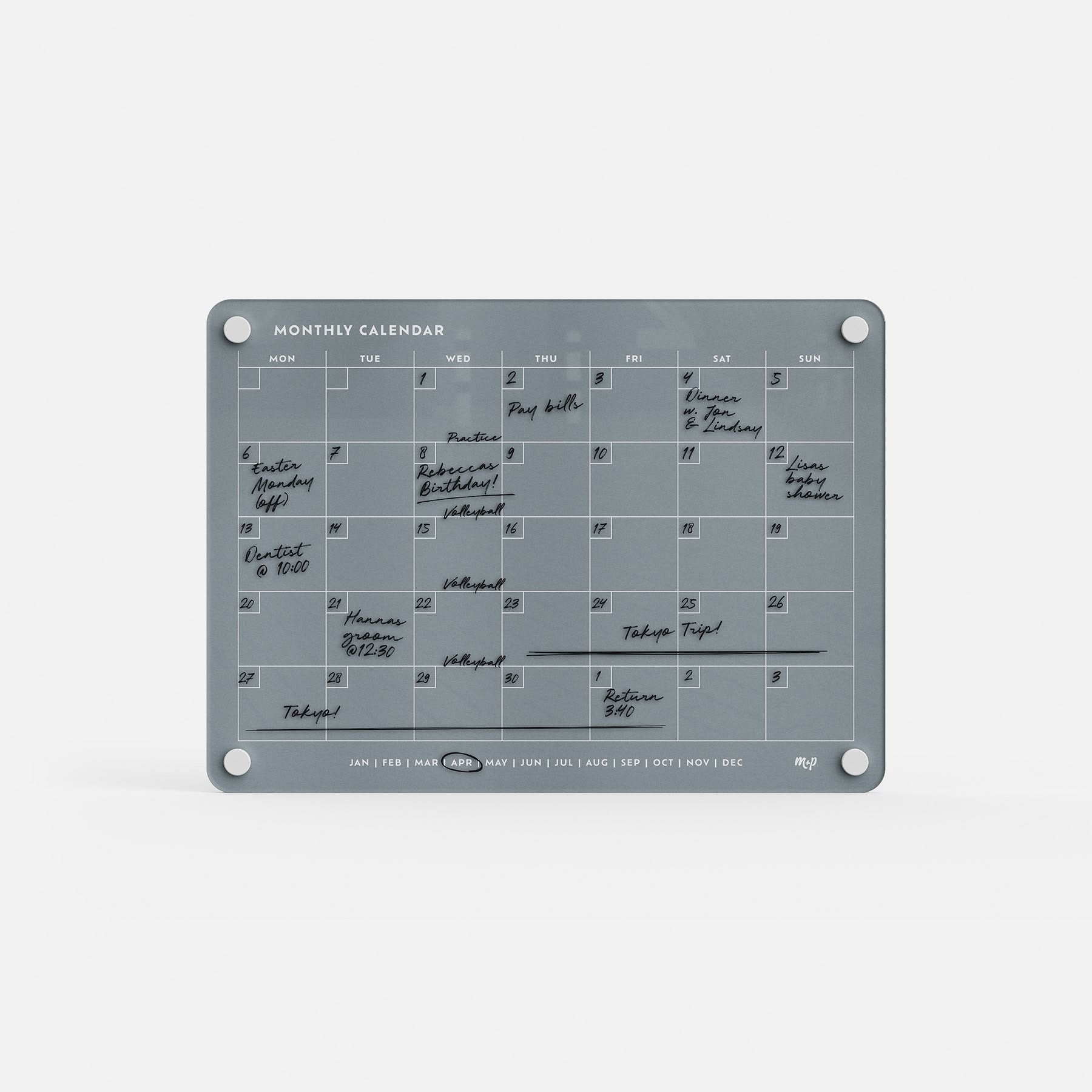 The Monthly Calendar 118 is a gray, reusable compact planner featuring handwritten black marker notes. With columns for each weekday and wall-mount circles in each corner, it’s perfect for organizing your month’s events.