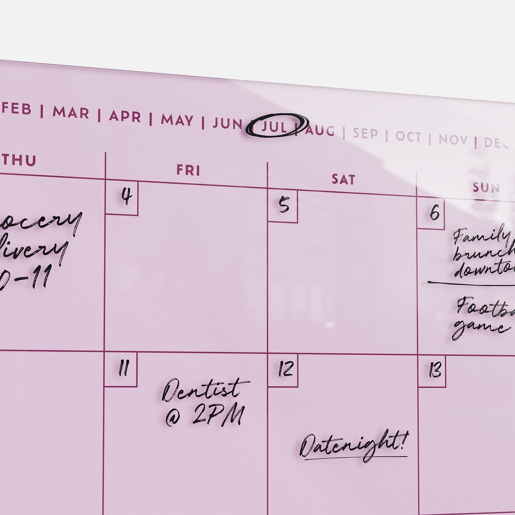 The premium acrylic Monkey and Pebbles Monthly Calendar 1411 in pink, erasable and reusable, tracks key July plans at a glance.