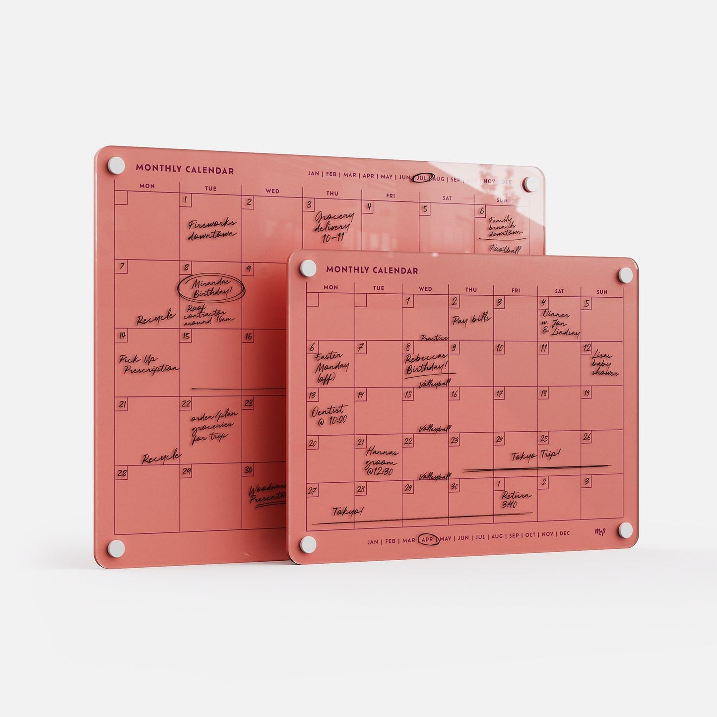 Two premium acrylic Monthly Calendar 1411 planners, erasable and reusable, in pink with white grommets, overlap on white.