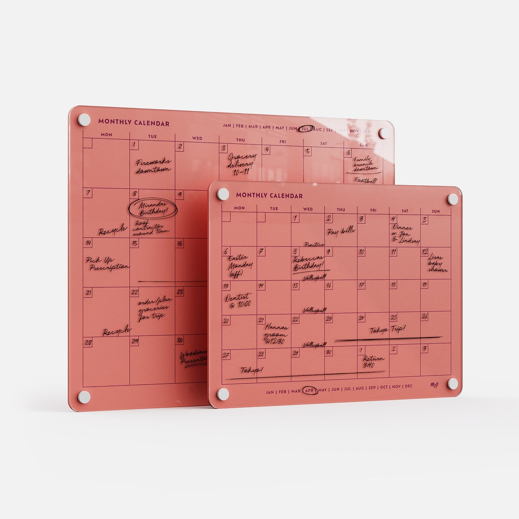 Two premium acrylic Monthly Calendar 1411 planners, erasable and reusable, in pink with white grommets, overlap on white.