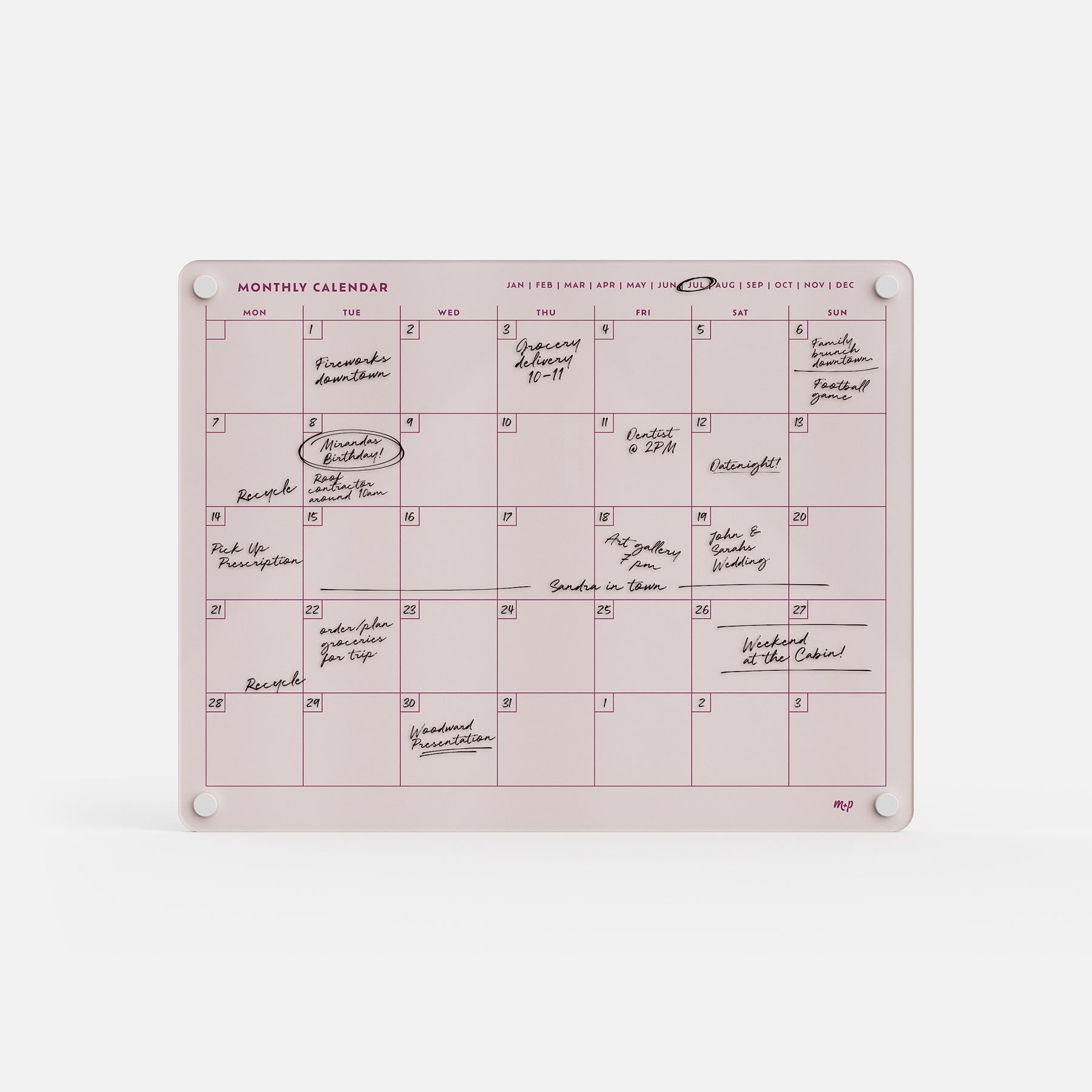The Monthly Calendar 1411 is a pink, dry-erase family planner with handwritten notes and four white magnets. Months are displayed in a row at the top for easy tracking of plans and events.