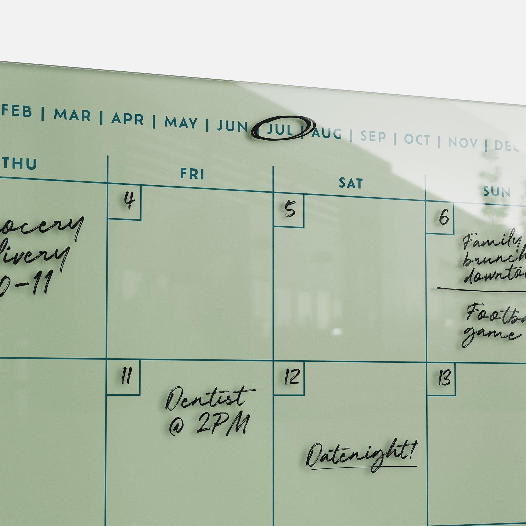 The Monkey and Pebbles premium acrylic monthly calendar 1411 is an erasable, reusable wall planner with July highlighted by a magnet.