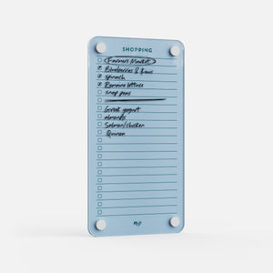 Angled view of a Vista blue magnetic acrylic shopping list board with a week of groceries written on it