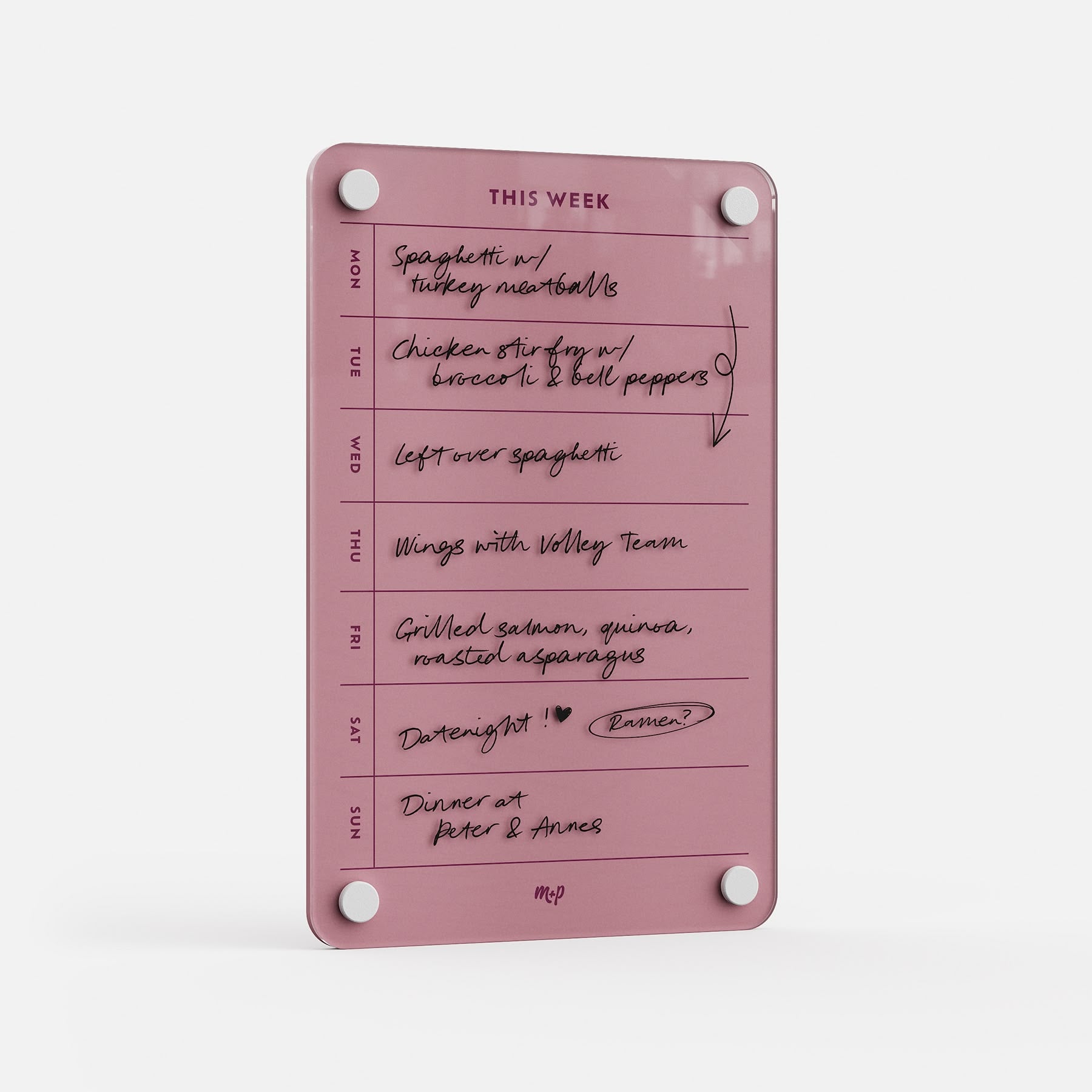 The "This Week 69" pink weekly organizer board features handwritten meal plans like spaghetti, chicken stir fry, wings, salmon, and dinner at Peter & Anne’s. Days of the week are listed on the left for hassle-free planning.