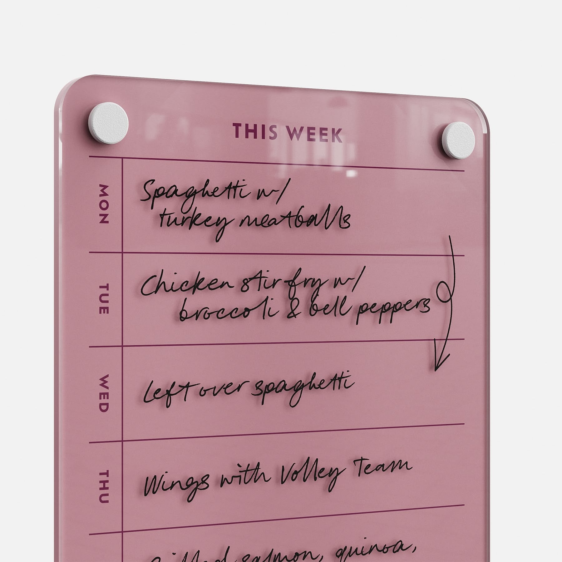 This Week 69 is a stylish pink weekly meal planner board, featuring handwritten meals like spaghetti with turkey meatballs, chicken stir fry, leftovers, and volleyball team wings—a chic kitchen organizer.