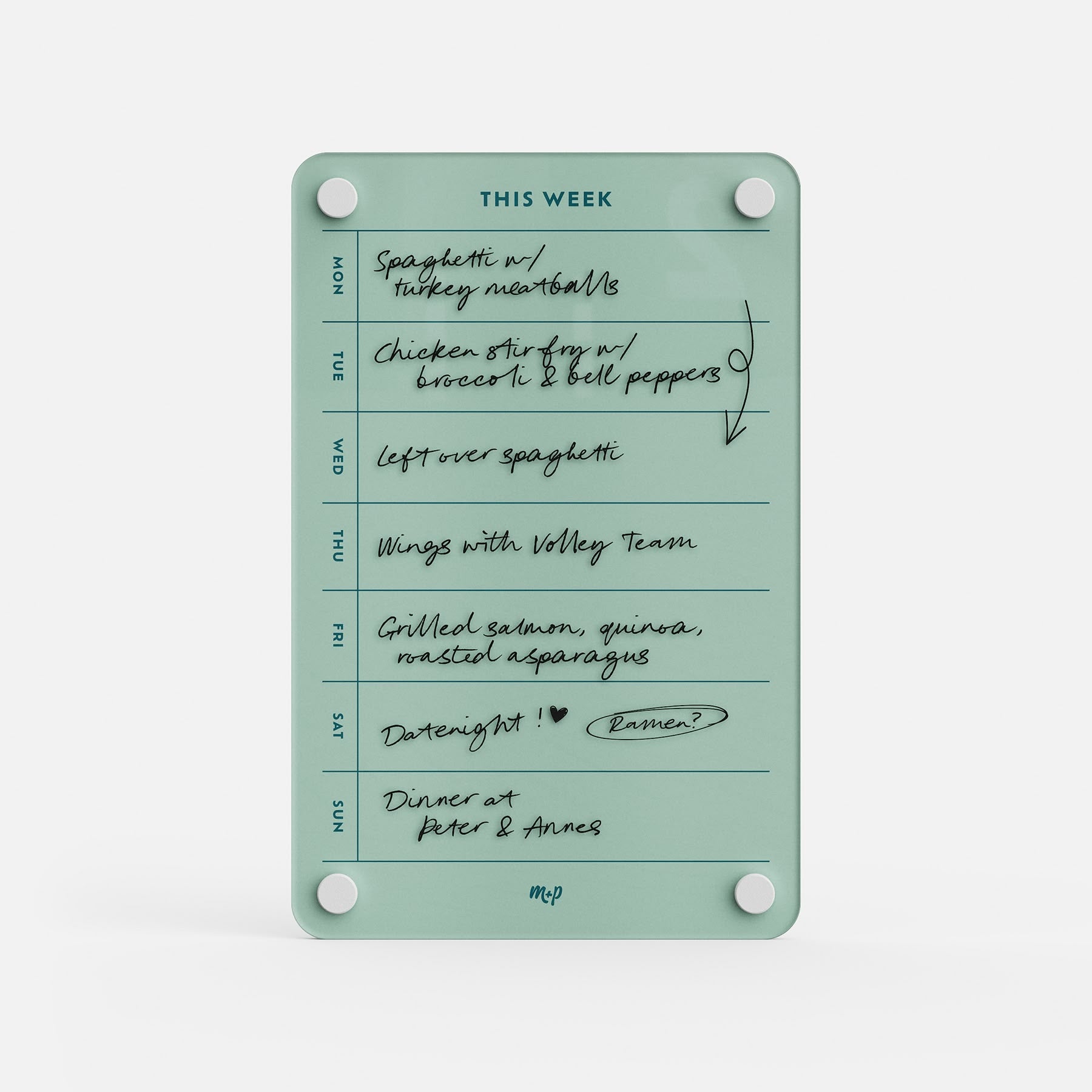 The This Week 69 organizer in teal features handwritten plans—spaghetti, chicken stir fry, wings, grilled salmon, date night dinner, and dinner at Peter & Anne’s—secured on the fridge with four white magnets.