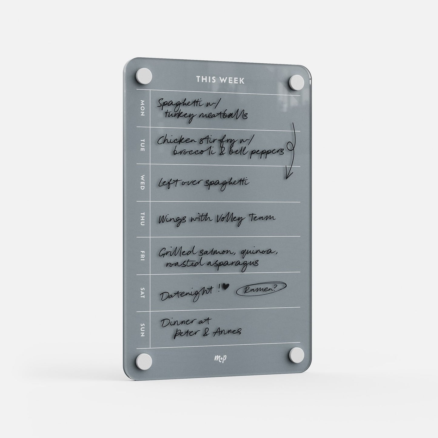 The This Week 69 is a gray glass weekly organizer featuring handwritten meal plans like spaghetti, chicken stir fry, wings, and grilled salmon. With days listed Monday to Sunday, it’s the perfect kitchen meal planner.