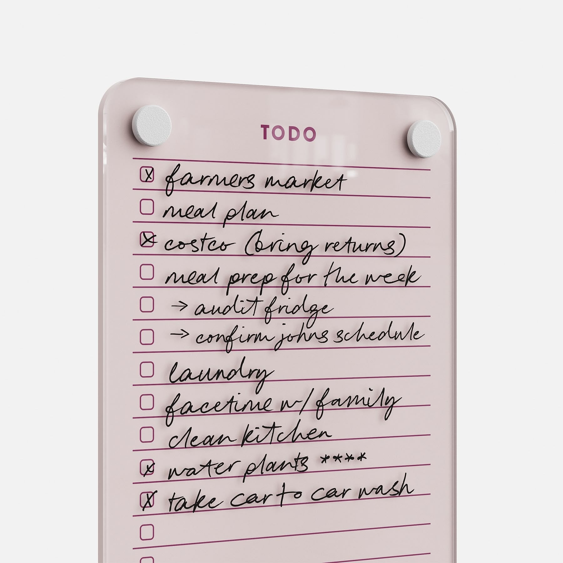 The Todo List 59 is a pink dry-erase to-do board with white magnets, displaying handwritten tasks like “farmers market,” “meal plan,” and “clean kitchen”—ideal for daily organization and easy task tracking.