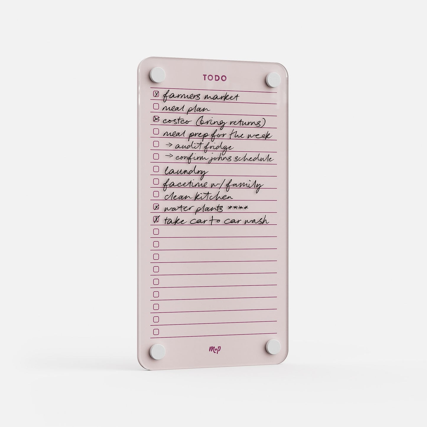 The Todo List 59 is a pink, rectangular magnetic daily dry-erase board with handwritten tasks—like farmers market and clean kitchen—some checked off. Mounted with four round magnets for easy display.