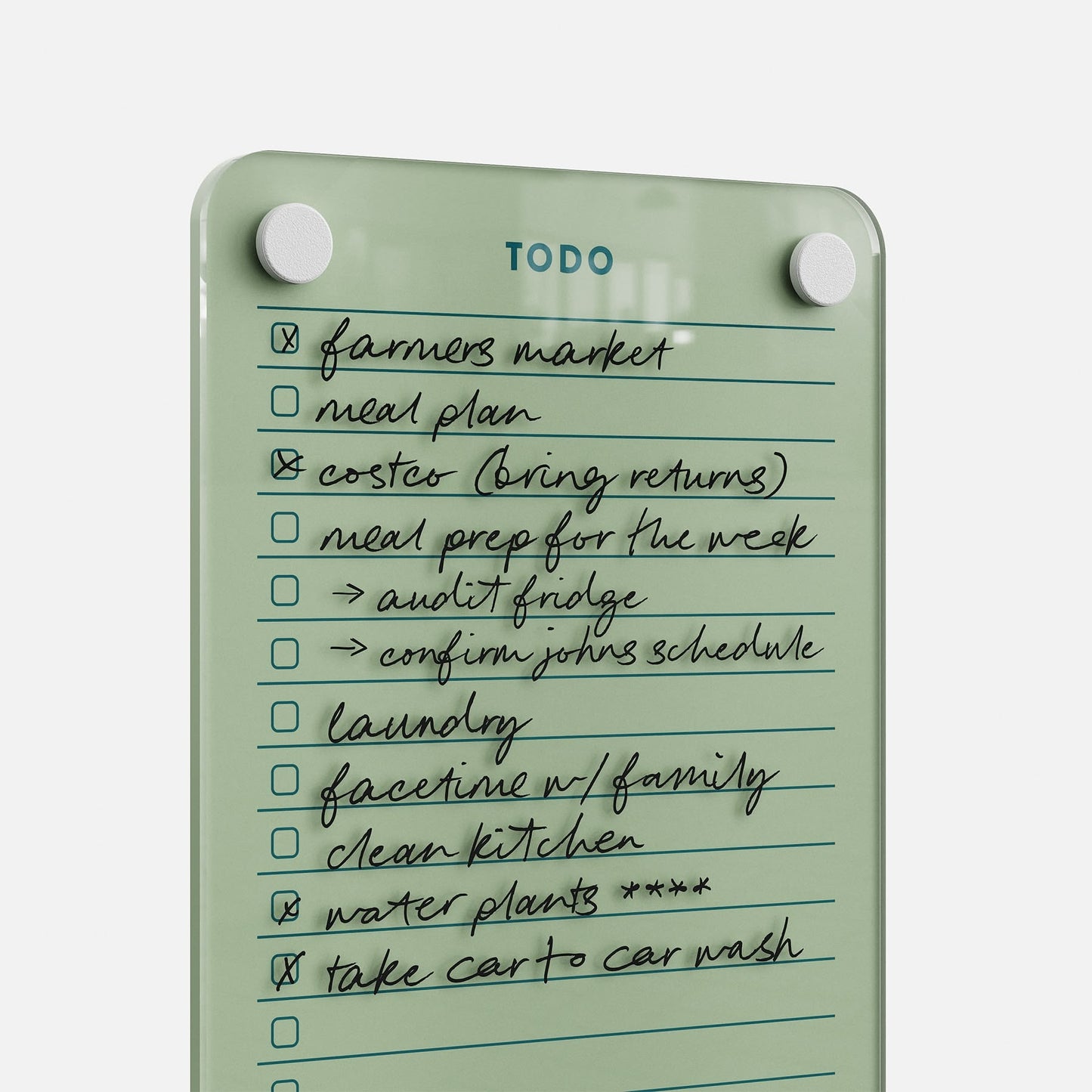 The Todo List 59 is a sleek clear glass daily organizer featuring ten handwritten tasks—like “farmers market,” “laundry,” and “take car to car wash”—with several items already checked off for effective task management.