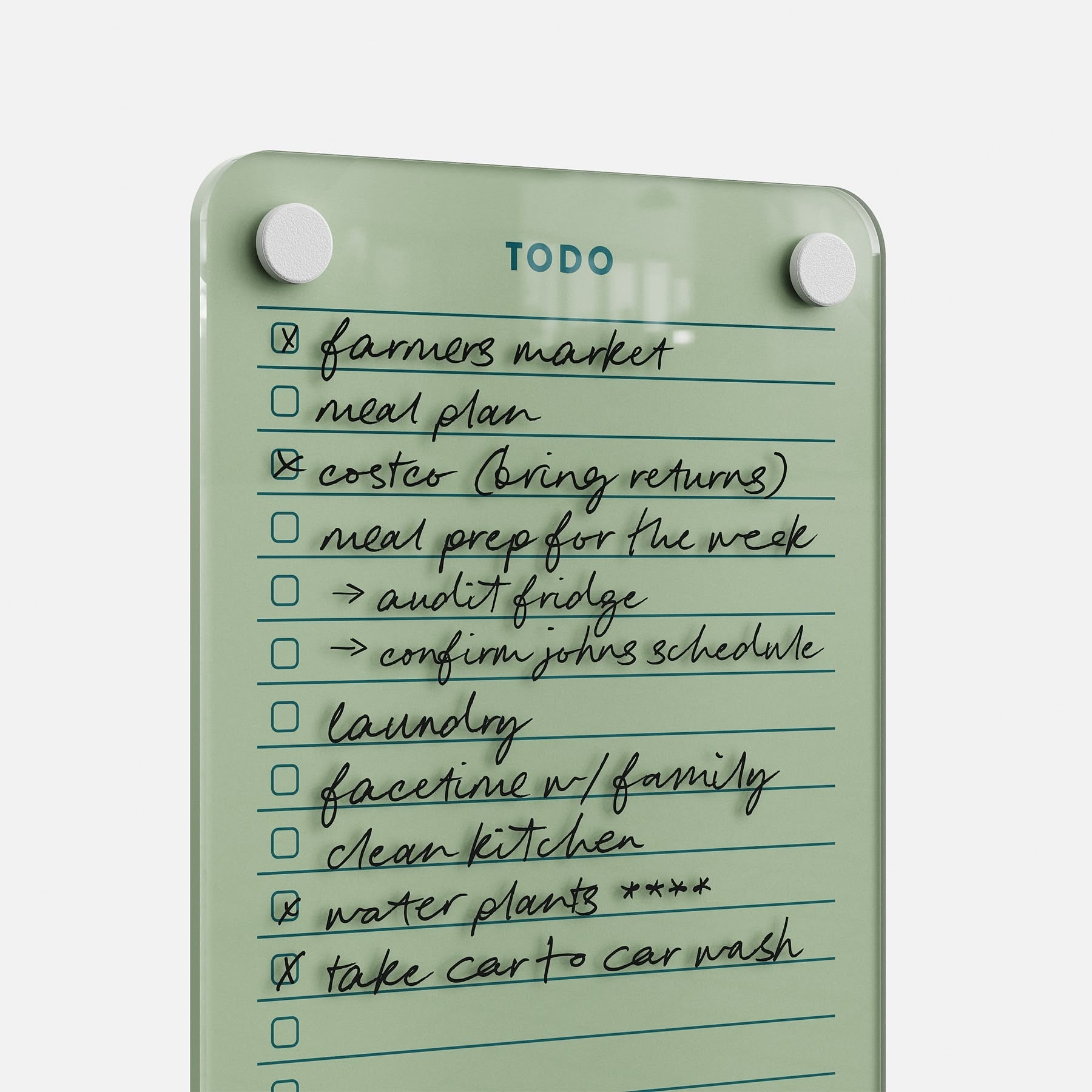 The Todo List 59 is a sleek clear glass daily organizer featuring ten handwritten tasks—like “farmers market,” “laundry,” and “take car to car wash”—with several items already checked off for effective task management.