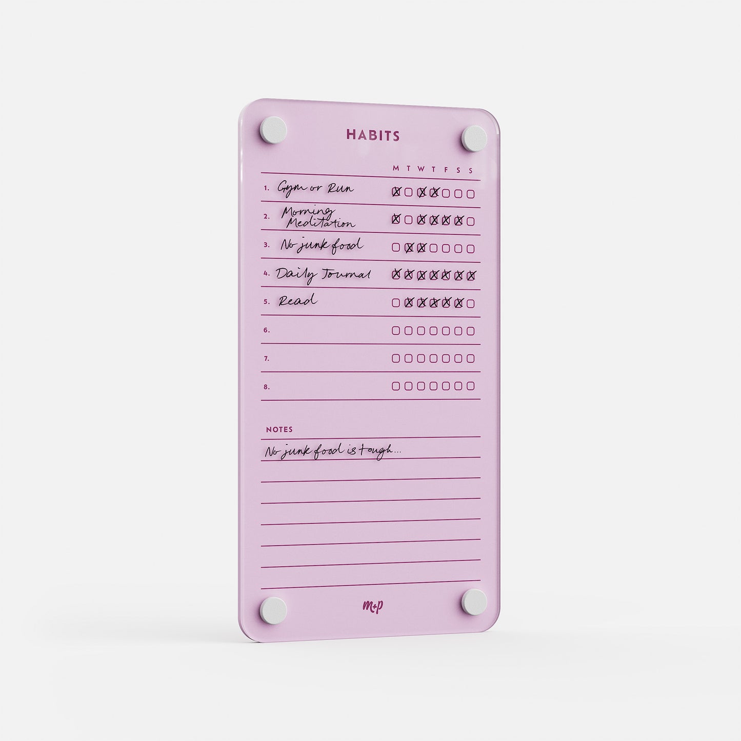 The Weekly Habits 59 pink magnetic tracker shows handwritten habits like Morning Meditation and Read, with daily checkboxes and a note at the bottom that says "No junk food is tough.
