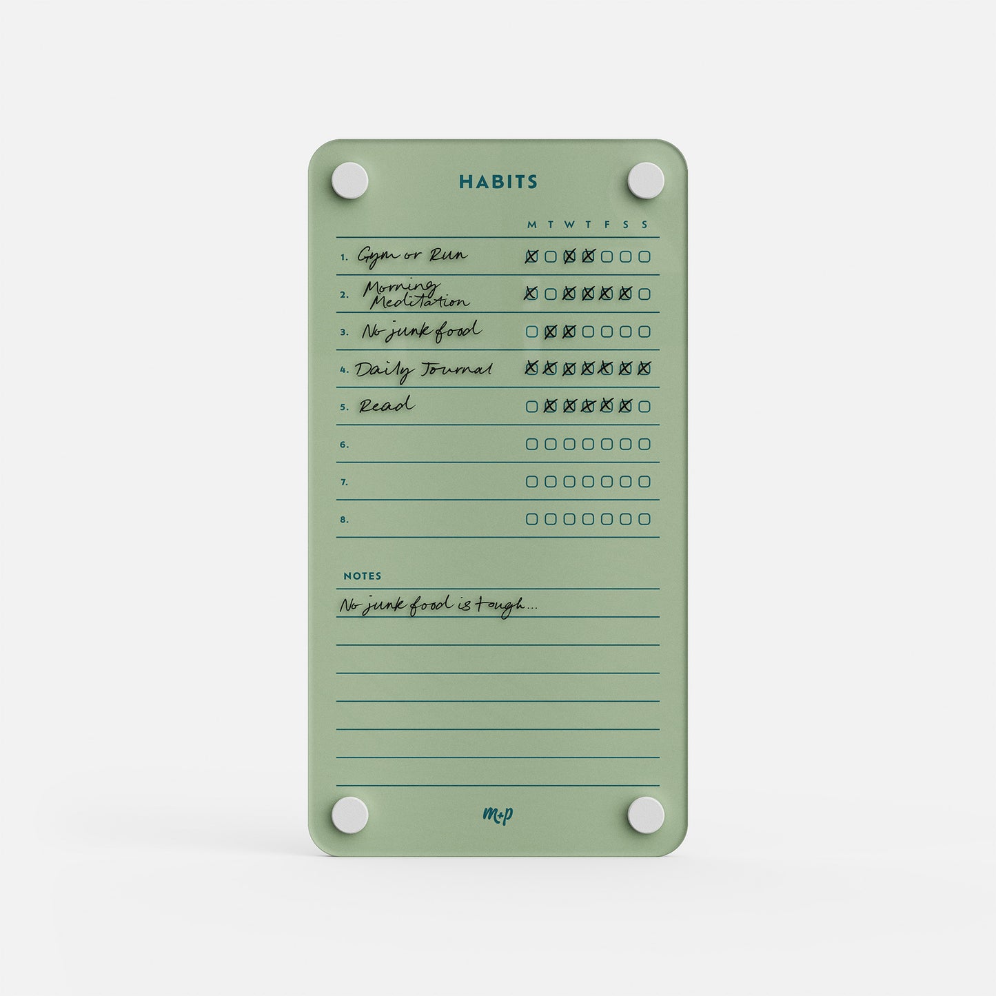 Premium acrylic erasable and reusable green habit tracker with handwritten daily goals, Xs/circles, and a note: “No junk food is tough...”.