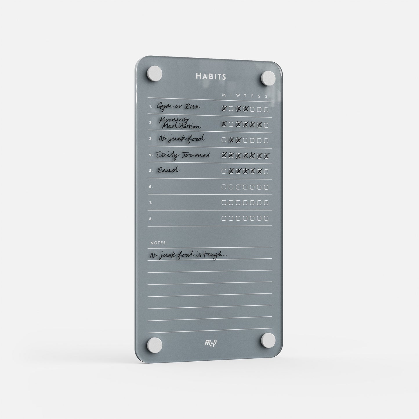 Weekly Habits 59 is a gray magnetic tracker for habits like Gym or Run, Morning Meditation, No junk food, Daily Journal, and Read. Days of the week checkboxes and a notes section (e.g., “No junk food is tough”) keep you motivated.