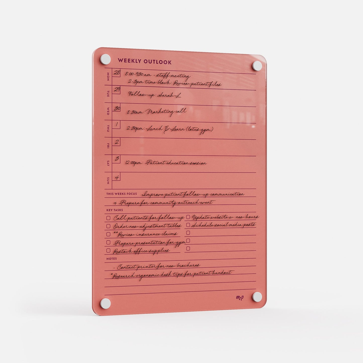 The Weekly Outlook 811 is a pink acrylic planner board and productivity organizer with sections for schedule, key ideas, notes, weekly focus, handwritten text, and four corner holes for mounting.