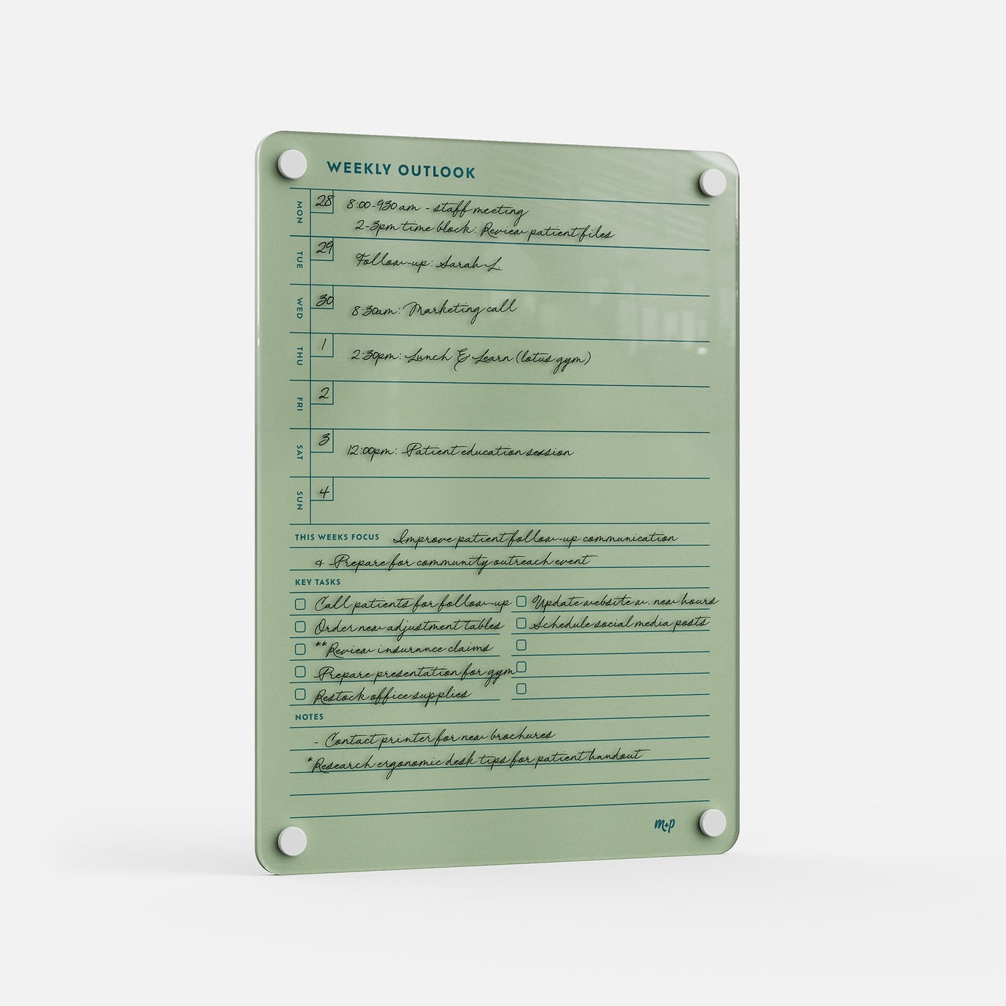 The Weekly Outlook 811 is a green dry-erase weekly planner and productivity organizer with black handwritten notes, showing times, appointments, key tasks, focus, and notes. It features four corner holes for easy mounting.